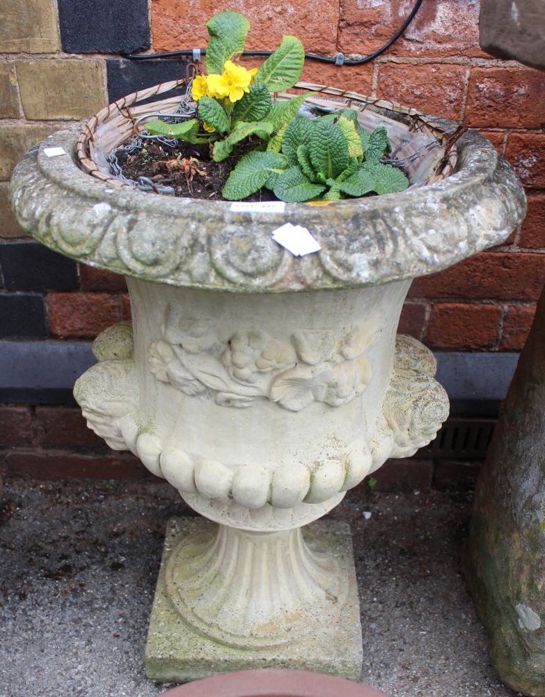 A cast garden urn of classic shape and form