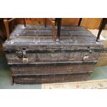 A large flat topped metal bound trunk