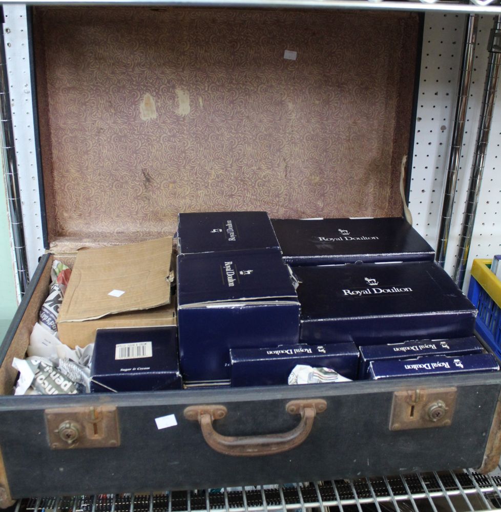 A suitcase of mostly "Royal Doulton" ceramic wares, mostly in original boxes