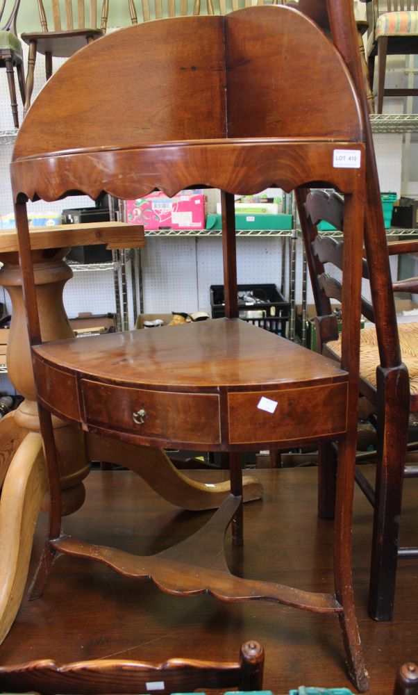 An Edwardian mahogany corner wash stand with single drawer to under tier