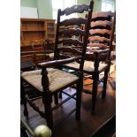 A set of eight ladder back rush seated dining chairs to include two carvers