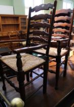 A set of eight ladder back rush seated dining chairs to include two carvers