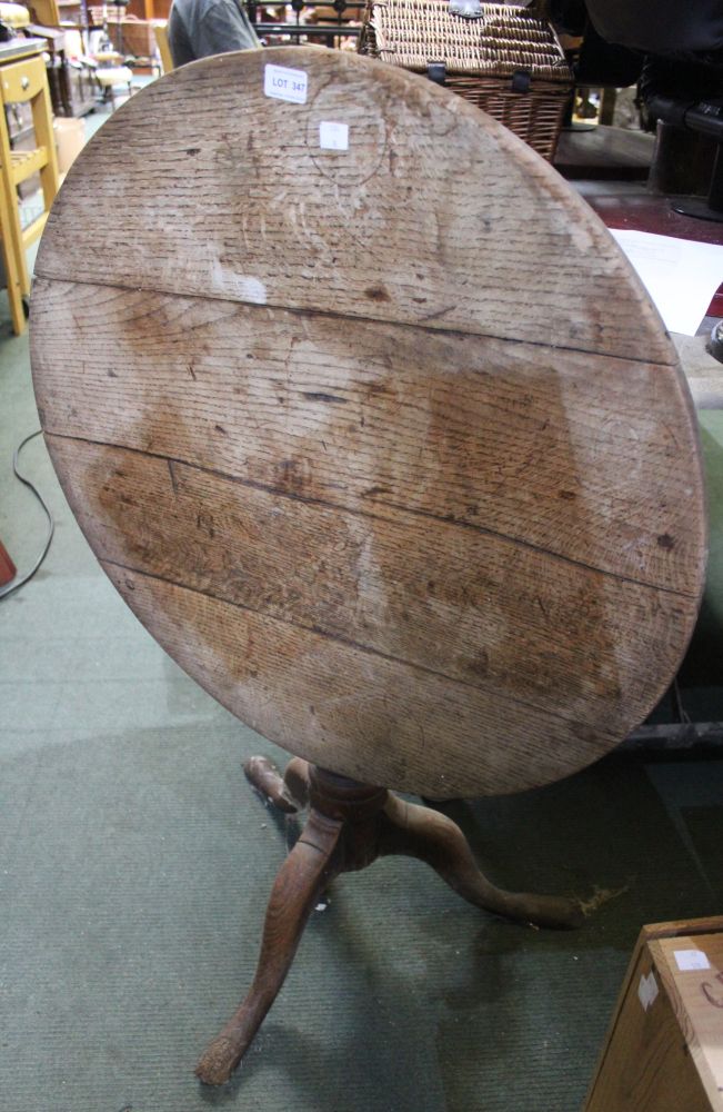 An oak topped flip top tripod table