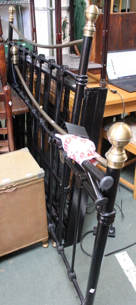 A modern metal framed gilt and black double bed