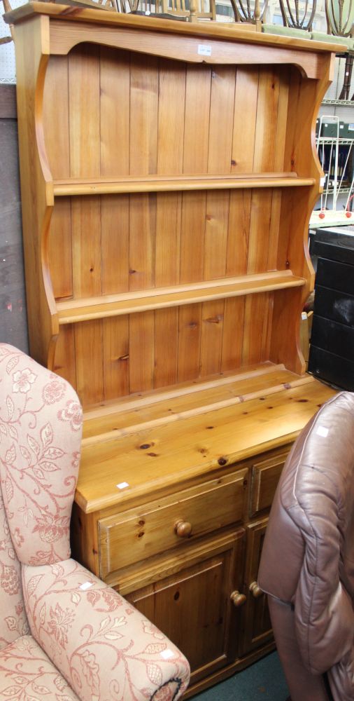 A pine kitchen dresser with three shelf plate rack