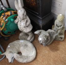 A selection of four cast garden ornaments including Peter Rabbit, a fox & two other examples