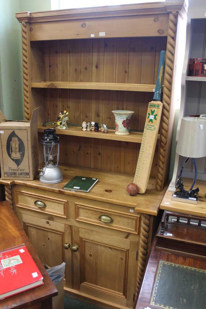 A rustic pine kitchen dresser, barley twist uprights. Two drawers over two cupboard doors