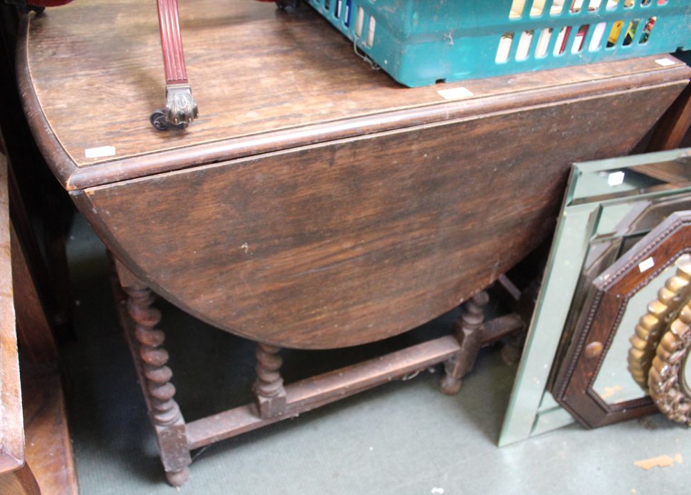 An oak gate leg table with barley twist legs