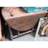 An oak gate leg table with barley twist legs