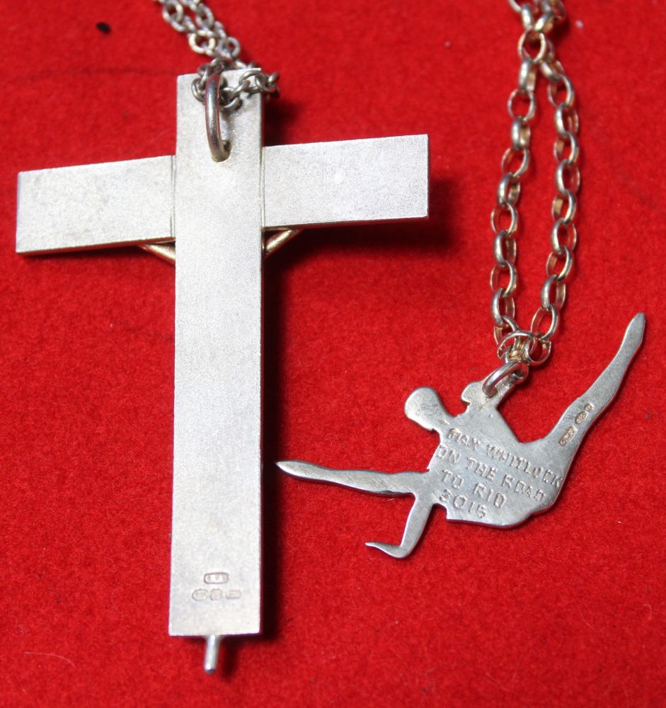 A silver Crucifix, bearing a 9ct gold Christ, on chain, together with a silver Gymnast pendant on ch - Image 2 of 2