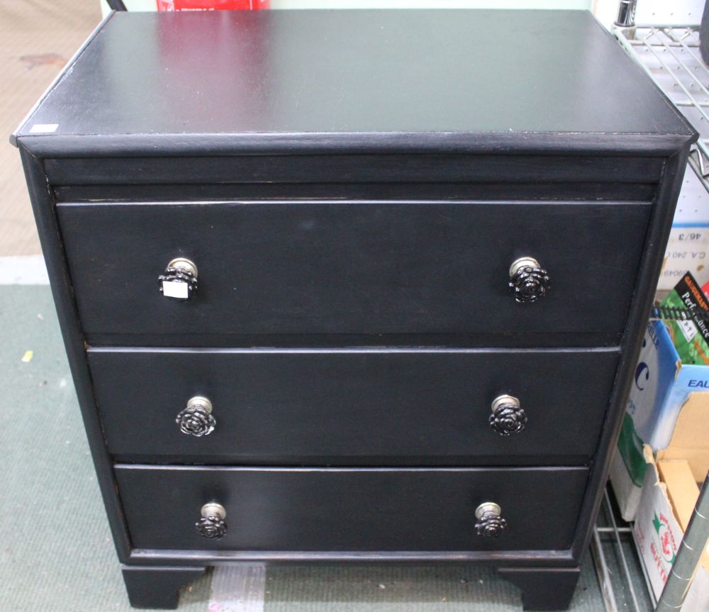 A small black painted chest of three drawers