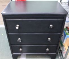 A small black painted chest of three drawers