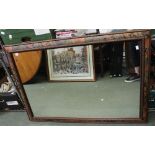 A large wall mirror with floral decorated frame