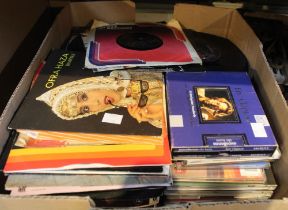 A box containing a large selection of vinyl 45's and some CD's