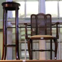 A mahogany two tier plant stand with a open armed bergere back Edwardian armchair