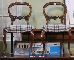 A pair of mahogany balloon back Victorian dining chairs with upholstered seats