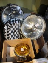 A box containing a pair of vintage car spot lights etc