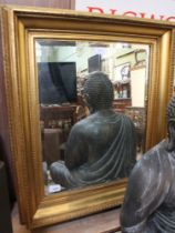 A gilt framed wall mirror