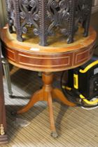 A reproduction circular drum table with inset leather top