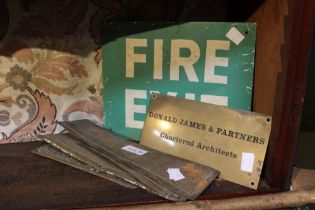 A vintage fire exit sign with a brass architects plaque and four vintage door finger plates