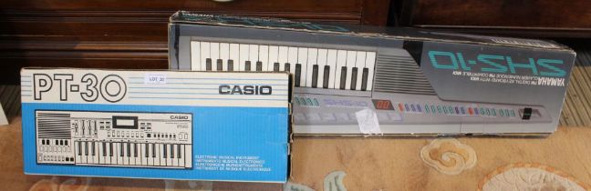 A Yamaha digital key board in original box with a Casio PT-30 key board in original box