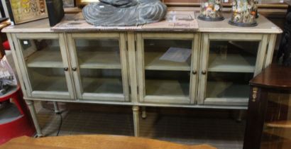 A painted long low four door display cabinet, 160cm wide x 40cm deep x 86cm high
