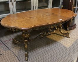 A modern brass based oak top coffee table