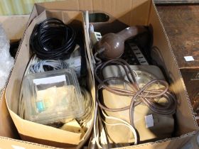 A box containing a selection of old telephones and associated equipment