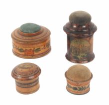 Four whitewood variously decorated Tunbridge ware pin cushions, comprising a cylinder box form