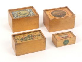 Four whitewood print and paint decorated rectangular boxes, all with sliding lids comprising an