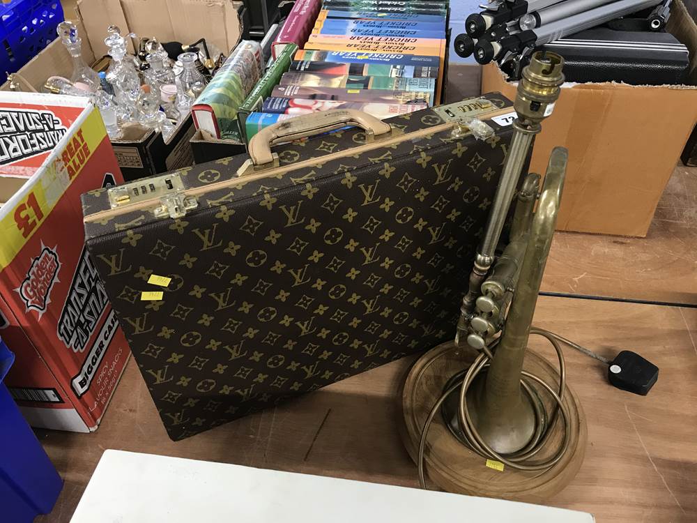 A briefcase and a trumpet lamp