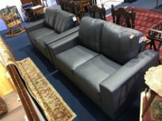 A pair of grey leather two seater settees