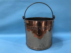 An Arts & Crafts design copper bucket, with swing handle