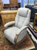 A grey swivel and recliner armchair