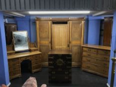 A Victorian aesthetic movement bedroom suite comprising; a triple door wardrobe, chest of drawers