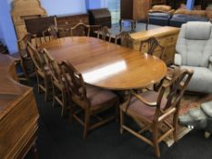 A reproduction mahogany dining table and ten chairs