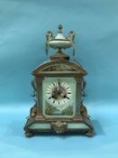 An early 20th Century French mantel clock with porcelain panels, eight day movement and strike
