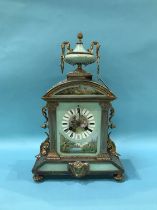 An early 20th Century French mantel clock with porcelain panels, eight day movement and strike