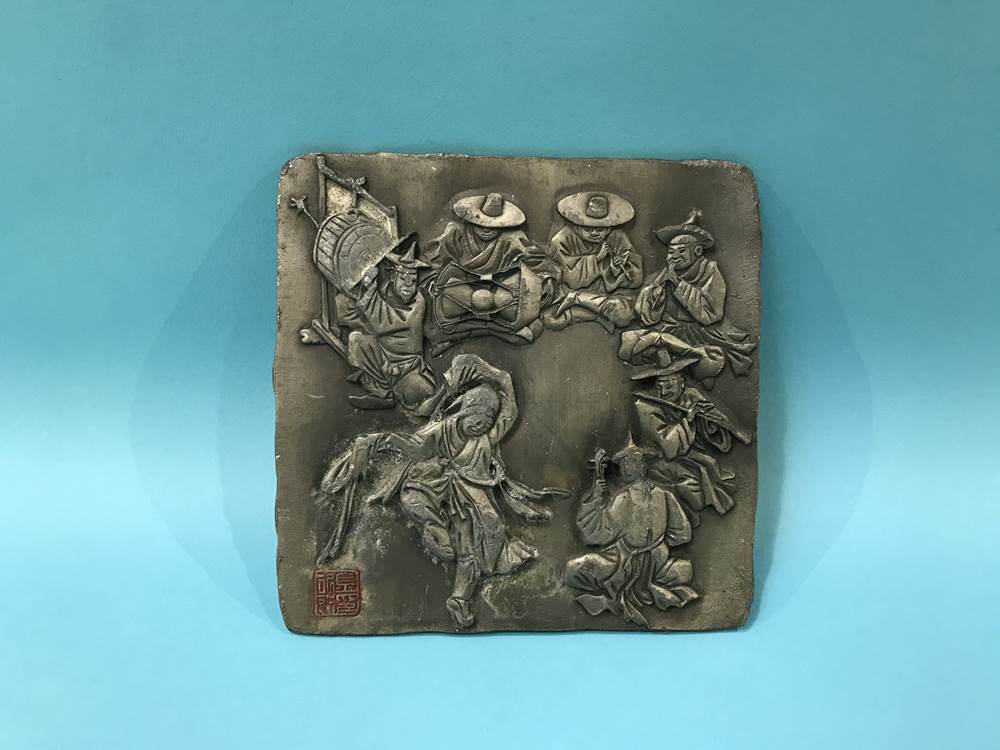An oriental metalwork relief plaque