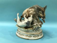A Continental porcelain group of a dog attacking a wild boar