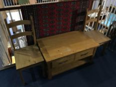 A low oak two drawer coffee table and a pair of chairs
