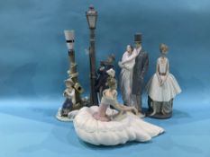 A collection of Nao and Lladro figures