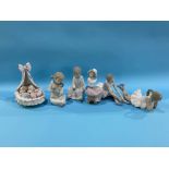 A Lladro group of two babies in a crib and five Nao figures