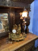 A figural lamp and a French style clock