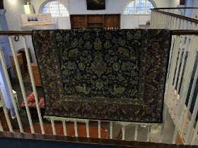 A part silk Persian rug, decorated with naturalistic foliage, birds and animals, 165cm x 106cm