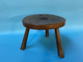 An oak three legged stool, signed underneath Jack Grimble, Cromer