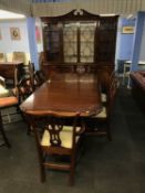A Charles Barr mahogany four door breakfast bookcase, a Charles Barr extending dining table with a