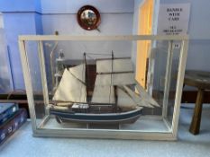 A cased model of a yacht