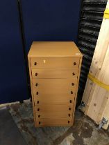 A narrow modern chest of eight drawers