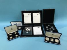 Silver proof coins in five cases, mostly UK